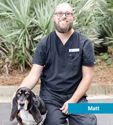 Staff member with black dog 